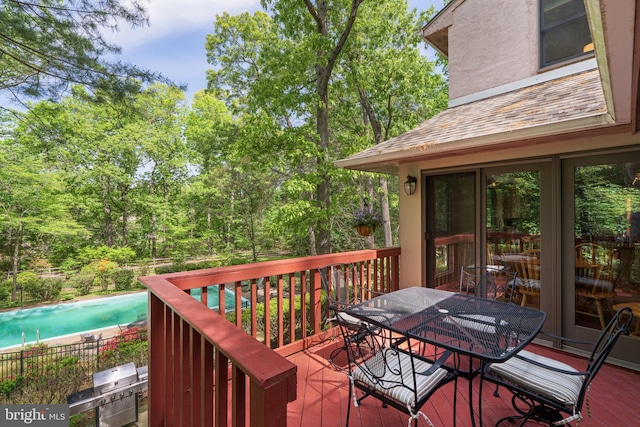 wooden deck featuring outdoor dining area and grilling area