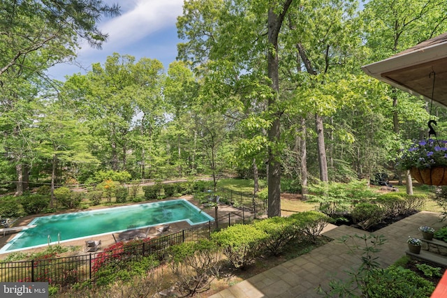 view of swimming pool with fence