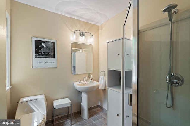bathroom with a shower, tile patterned flooring, and toilet
