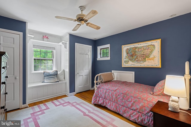bedroom with wood finished floors and a ceiling fan