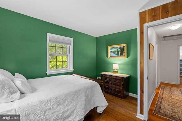 bedroom with wood finished floors and baseboards