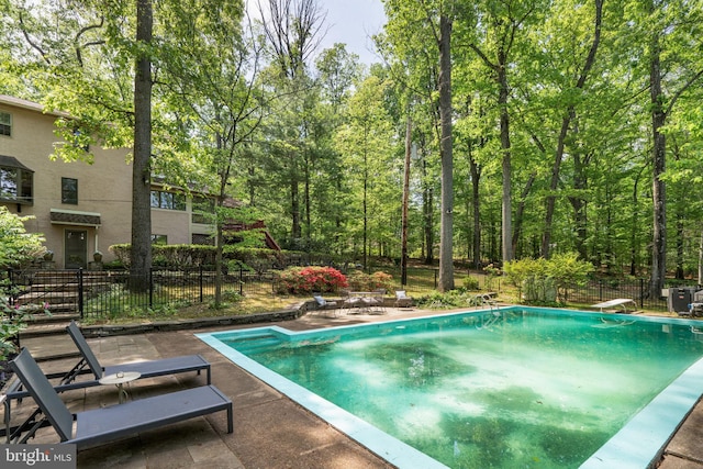 view of pool with fence and a patio area