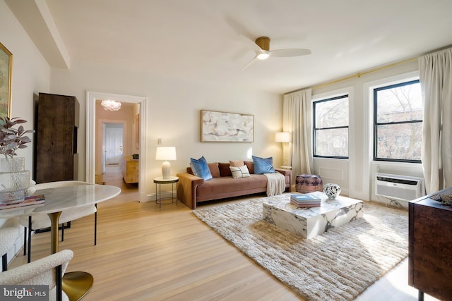 living room featuring light wood-style flooring, ceiling fan, and cooling unit