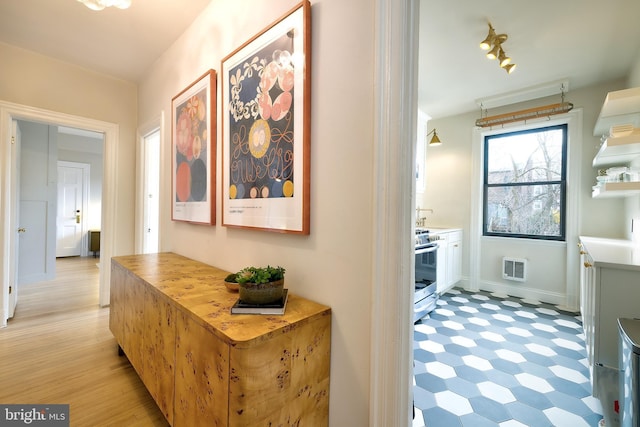 hallway with light floors and baseboards