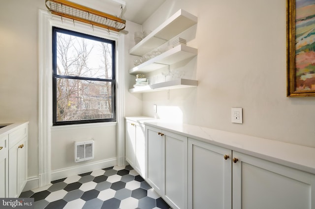 bar featuring dark floors and baseboards