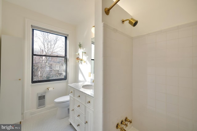 bathroom with toilet, vanity, tile patterned floors, and a shower