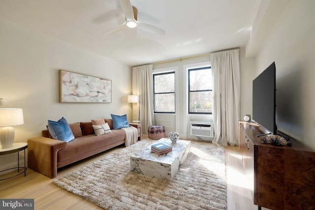 living room with wood finished floors, ceiling fan, and an AC wall unit
