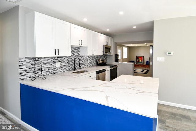 1210 Lindsay Rd, Oxon Hill, MD 20745 - kitchen with appliances with stainless steel finishes, a sink, backsplash, light stone countertops, and recessed lighting