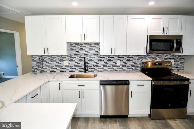 1210 Lindsay Rd, Oxon Hill, MD 20745 - kitchen with appliances with stainless steel finishes, a sink, white cabinets, and recessed lighting
