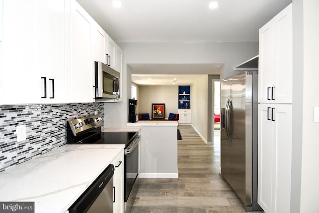 1210 Lindsay Rd, Oxon Hill, MD 20745 - kitchen with stainless steel appliances, light wood-type flooring, white cabinetry, decorative backsplash, and recessed lighting