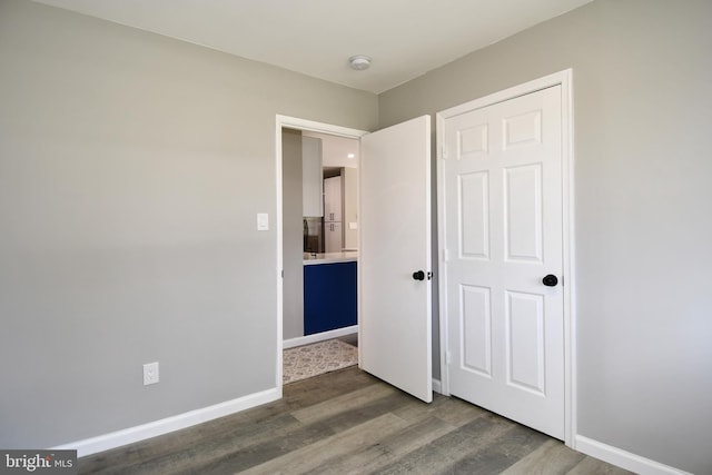 1210 Lindsay Rd, Oxon Hill, MD 20745 - unfurnished bedroom featuring wood finished floors and baseboards