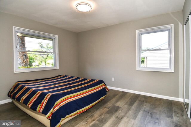 1210 Lindsay Rd, Oxon Hill, MD 20745 - bedroom with baseboards, multiple windows, and wood finished floors