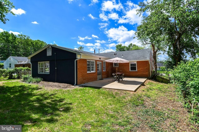 1210 Lindsay Rd, Oxon Hill, MD 20745 - back of house featuring a patio, a lawn, and brick siding