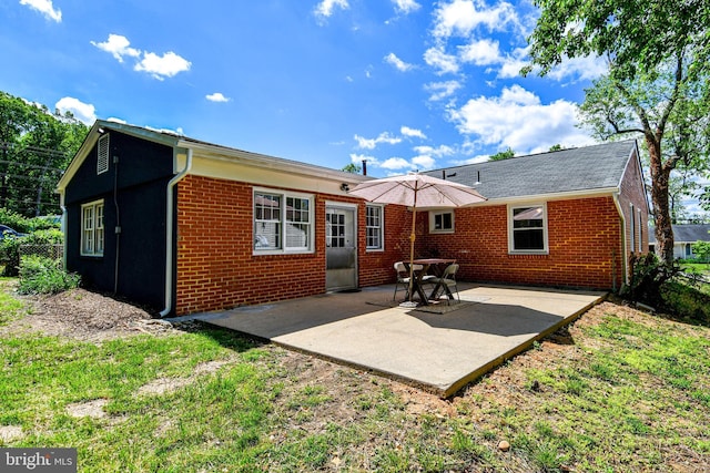 1210 Lindsay Rd, Oxon Hill, MD 20745 - back of property with brick siding and a patio area