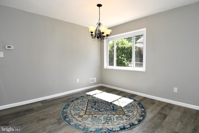 1210 Lindsay Rd, Oxon Hill, MD 20745 - unfurnished dining area with a chandelier, baseboards, and dark wood-style flooring