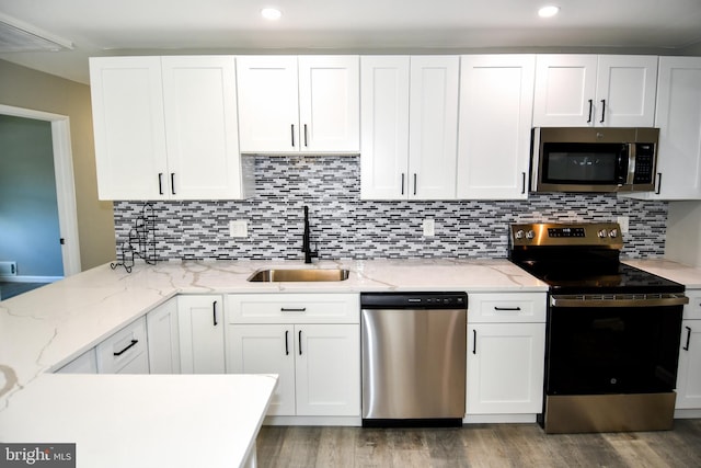 1210 Lindsay Rd, Oxon Hill, MD 20745 - kitchen featuring stainless steel appliances, a sink, white cabinetry, wood finished floors, and recessed lighting