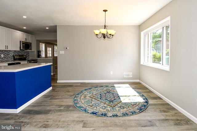 1210 Lindsay Rd, Oxon Hill, MD 20745 - kitchen featuring appliances with stainless steel finishes, light countertops, a chandelier, wood finished floors, and recessed lighting
