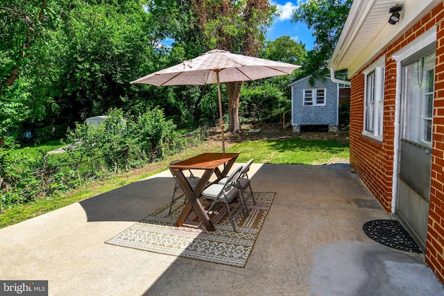 1210 Lindsay Rd, Oxon Hill, MD 20745 - view of patio featuring a storage unit and an outbuilding