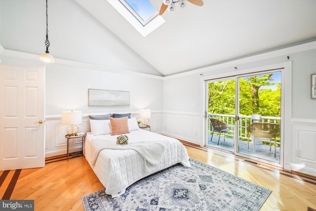 1233 Boucher Ave, Annapolis, MD 21403 - bedroom featuring access to exterior, wainscoting, vaulted ceiling, a skylight, and a decorative wall