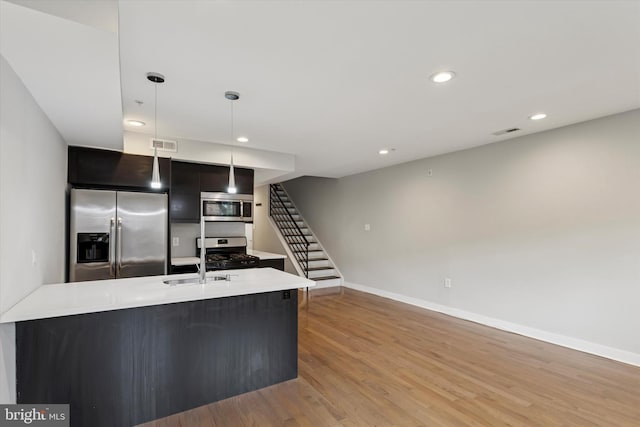 1524 N 2nd St Unit 2, Philadelphia, PA 19122 - kitchen with appliances with stainless steel finishes, hanging light fixtures, light countertops, light wood finished floors, and modern cabinets
