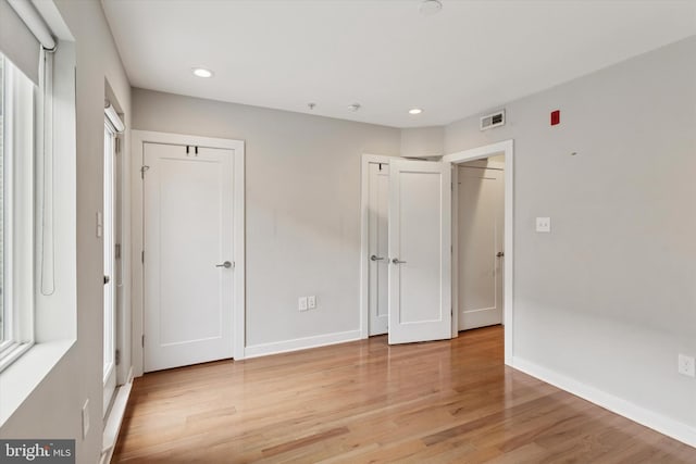 1524 N 2nd St Unit 2, Philadelphia, PA 19122 - unfurnished bedroom with recessed lighting, light wood-style flooring, baseboards, and two closets