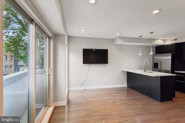 1524 N 2nd St Unit 2, Philadelphia, PA 19122 - kitchen featuring stainless steel refrigerator with ice dispenser, a sink, light countertops, dark cabinets, and baseboards