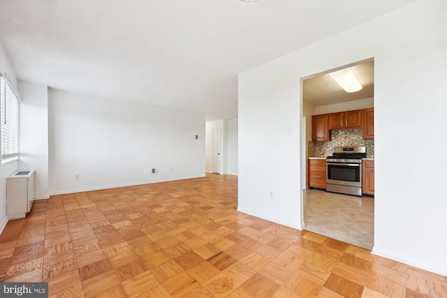 unfurnished living room featuring baseboards