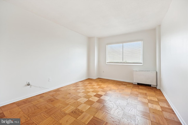 empty room featuring baseboards