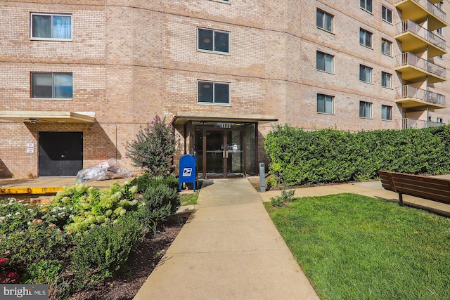 property entrance featuring brick siding and french doors