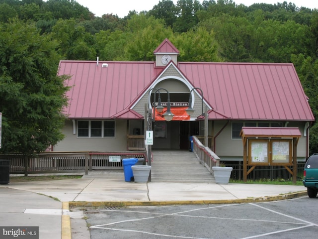 view of property with a view of trees and central AC unit