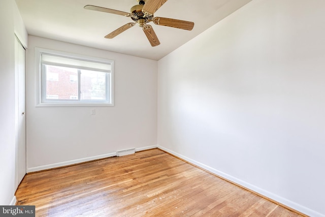 empty room with light wood finished floors, baseboards, and ceiling fan