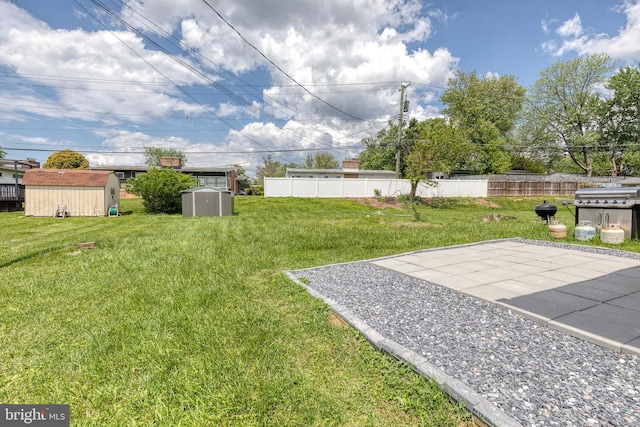 view of yard featuring a storage shed, an outdoor structure, and a patio