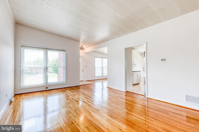 unfurnished room featuring light wood-type flooring and baseboards