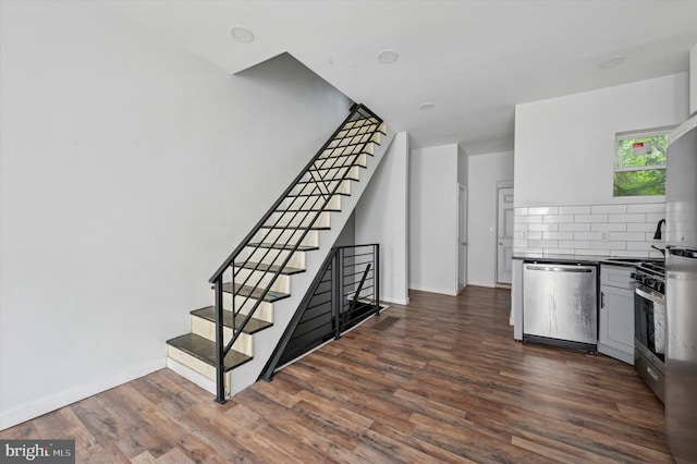 2214 N Cleveland St, Philadelphia, PA 19132 - kitchen with appliances with stainless steel finishes, dark wood-type flooring, dark countertops, and baseboards