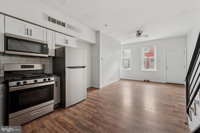 2214 N Cleveland St, Philadelphia, PA 19132 - kitchen featuring stainless steel appliances, dark countertops, decorative backsplash, and a ceiling fan