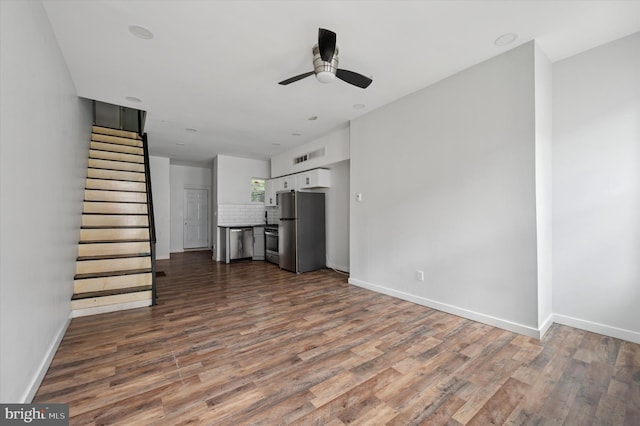 2214 N Cleveland St, Philadelphia, PA 19132 - unfurnished living room featuring a ceiling fan, stairway, dark wood-style flooring, and baseboards