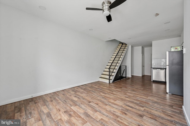 2214 N Cleveland St, Philadelphia, PA 19132 - unfurnished living room with wood finished floors, stairs, ceiling fan, and baseboards