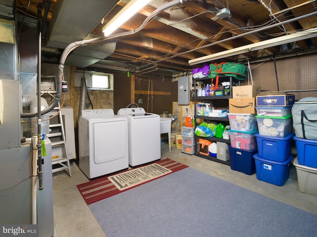 718 Moore Ave, Bryn Mawr, PA 19010 - basement featuring washing machine and dryer, electric panel, and heating unit