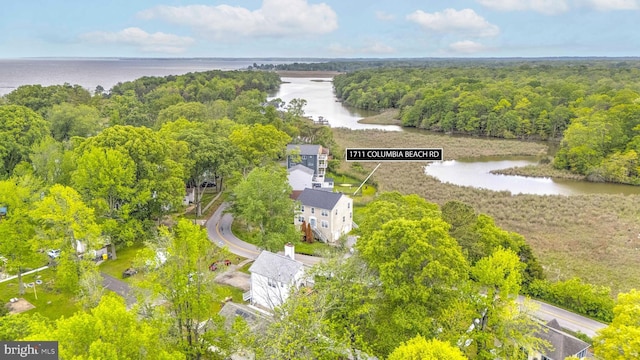 bird's eye view of a nearby body of water and a heavily wooded area
