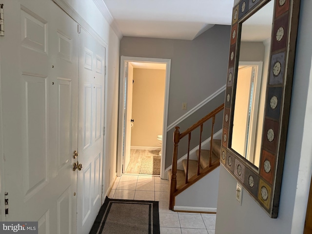 corridor featuring light tile patterned floors and stairway