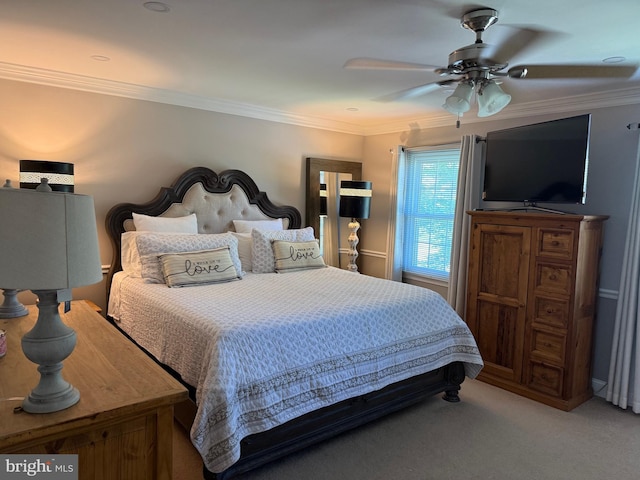 carpeted bedroom with ornamental molding and ceiling fan