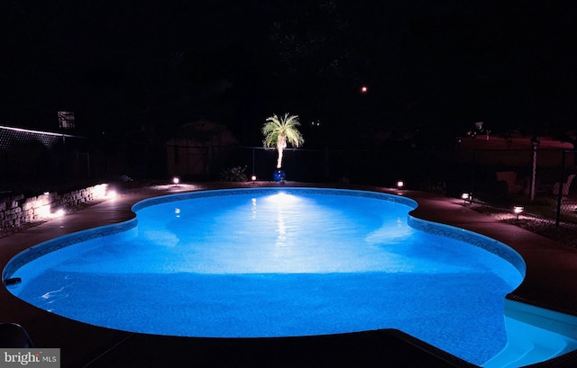 pool at twilight with fence