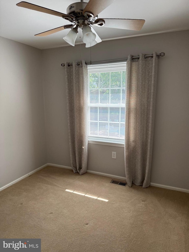 unfurnished room featuring ceiling fan, carpet, and baseboards