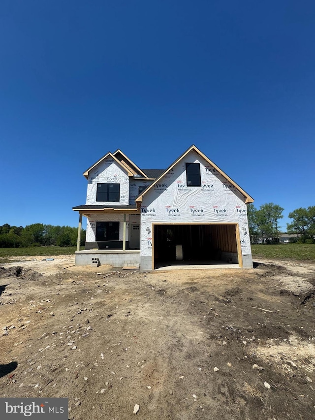 unfinished property featuring a garage