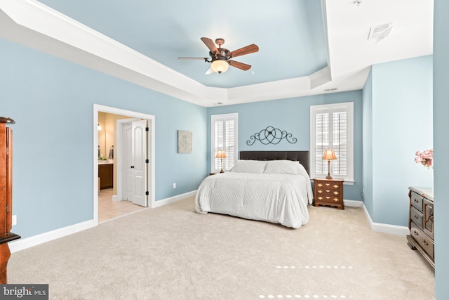 4108 Brushfield Dr, Frederick, MD 21704 - bedroom with a tray ceiling, light carpet, baseboards, ensuite bathroom, and ceiling fan