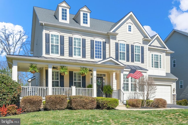 4108 Brushfield Dr, Frederick, MD 21704 - view of front of home featuring covered porch, a standing seam roof, a garage, metal roof, and a front yard