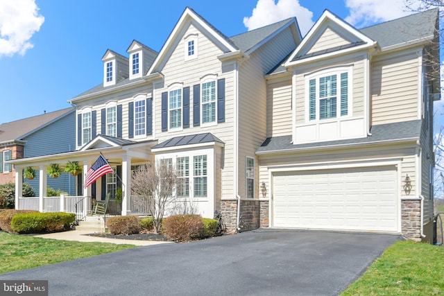 4108 Brushfield Dr, Frederick, MD 21704 - view of front of house with driveway, stone siding, a porch, a garage, and a shingled roof