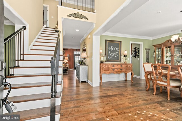 4108 Brushfield Dr, Frederick, MD 21704 - foyer entrance with stairs, ornamental molding, wood finished floors, and baseboards