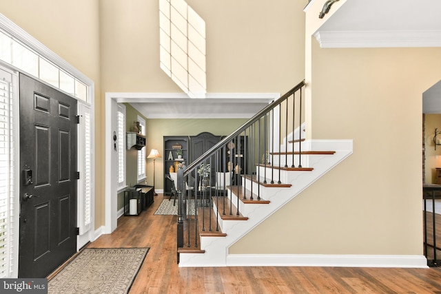 4108 Brushfield Dr, Frederick, MD 21704 - foyer with ornamental molding, stairs, wood finished floors, a towering ceiling, and baseboards