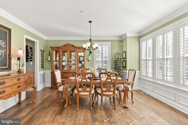 4108 Brushfield Dr, Frederick, MD 21704 - dining room with a decorative wall, wainscoting, a chandelier, wood finished floors, and crown molding